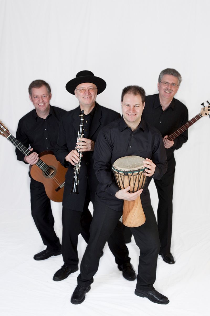 4 heitere Musiker mit ihren Instrumenten