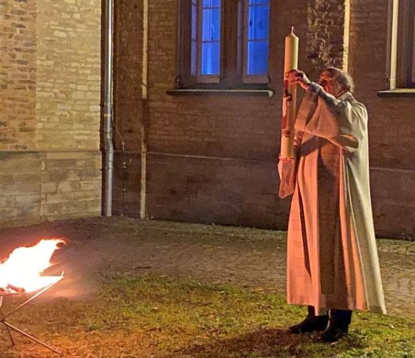 Pfr Winfiried Hommel mit der frisch entzündeten Osterkerze am Osterfeuer auf dem Jakobsberg