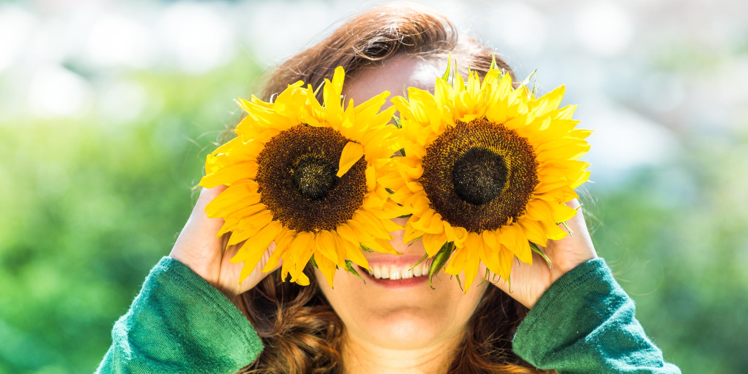 Junge Frau mit Sonnenblumen-Brille
