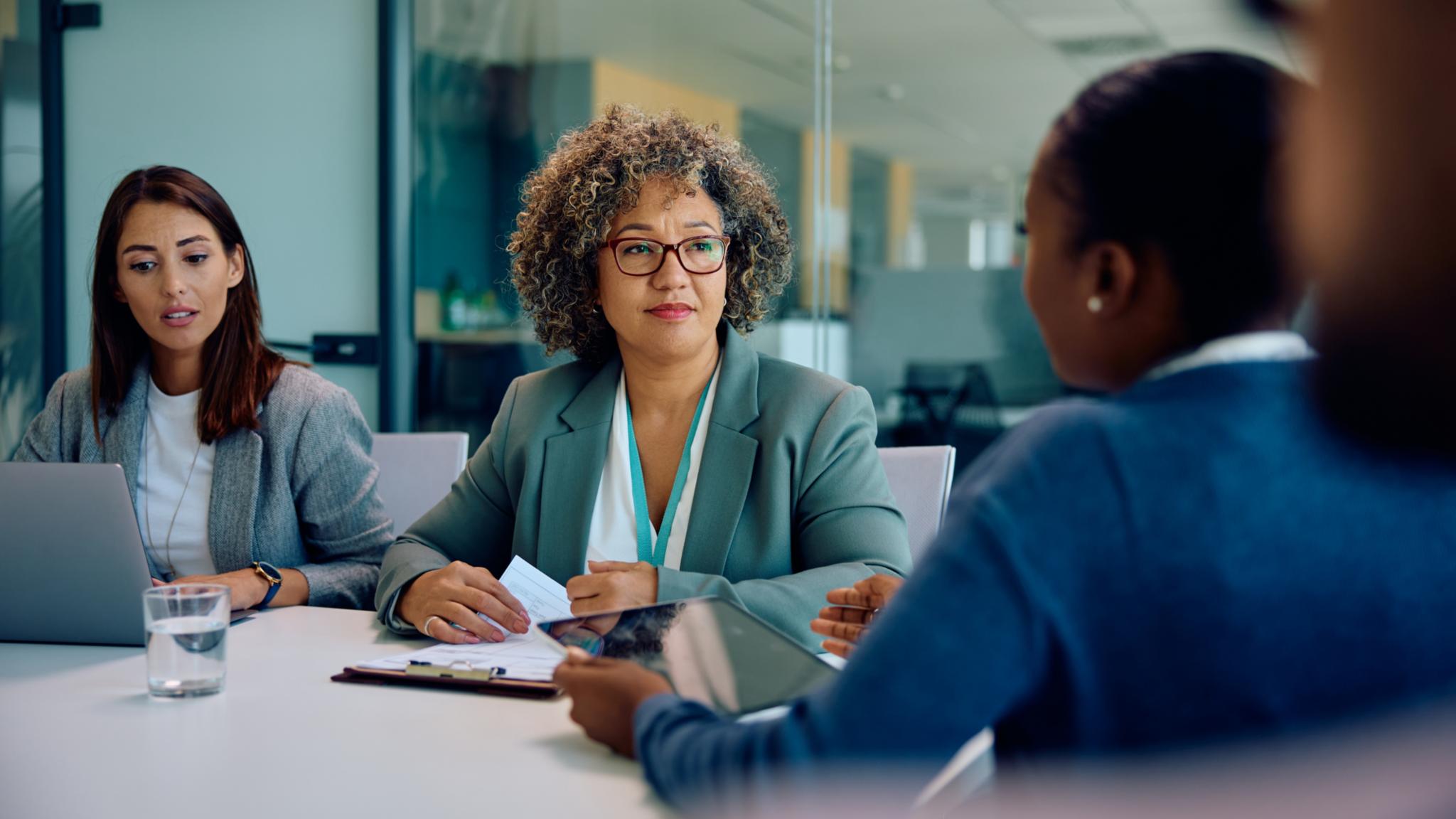 CEO having meeting with her business team in office.