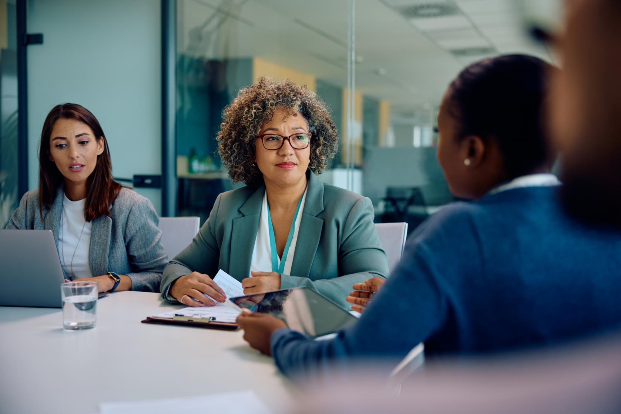 CEO having meeting with her business team in office.