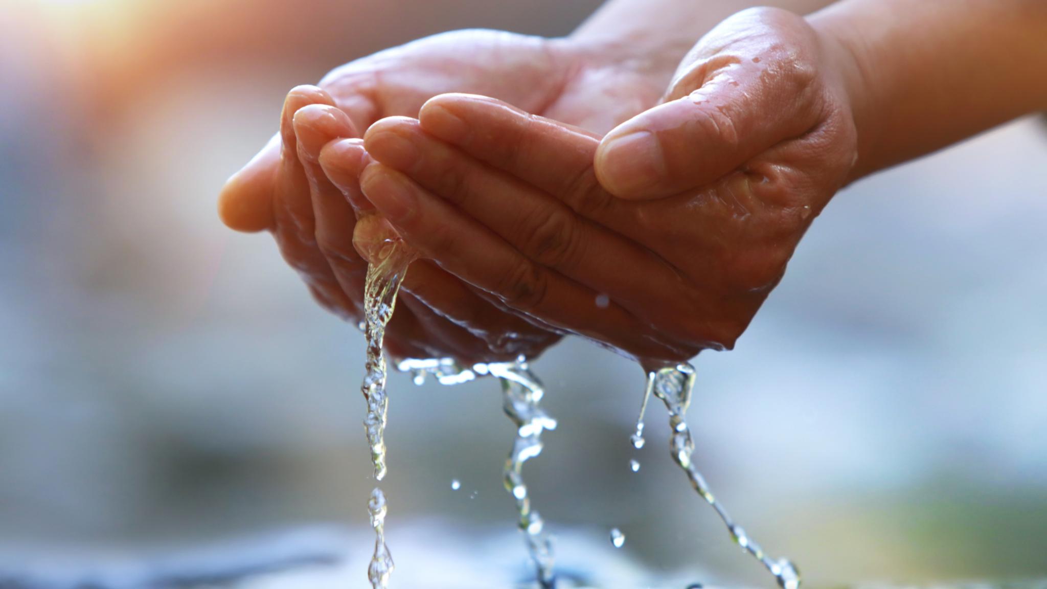 Wasser mit den Händen auffangen