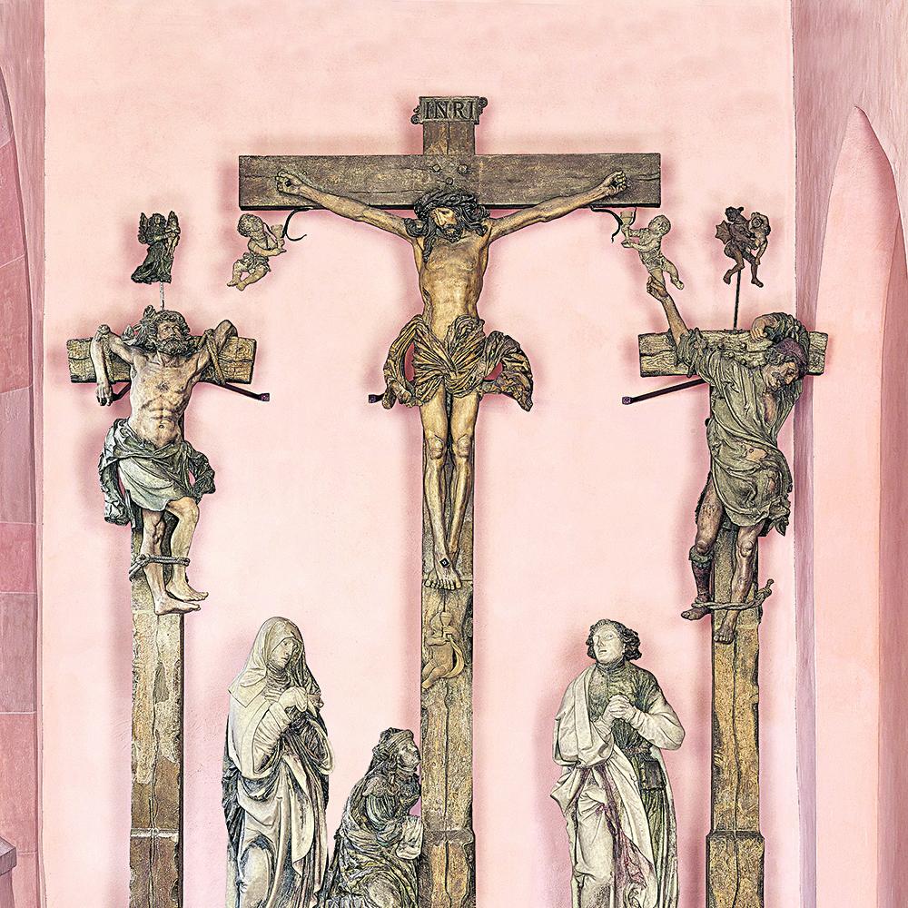 Die Kreuzigungsgruppe stiftete der Künstler Hans Backoffen, sie stammt aus seiner Werkstatt und ist zwischen 1518 und 1520 entstanden. Das Original ist heute im Bischöflichen Dom- und Diözesanmuseum in Mainz zu sehen. Am ursprünglichen Standort neben der Pfarrkirche St. Ignaz in der Mainzer Altstadt steht eine Kopie. (c) Bischöfliches Dom-und Diözesanmuseum