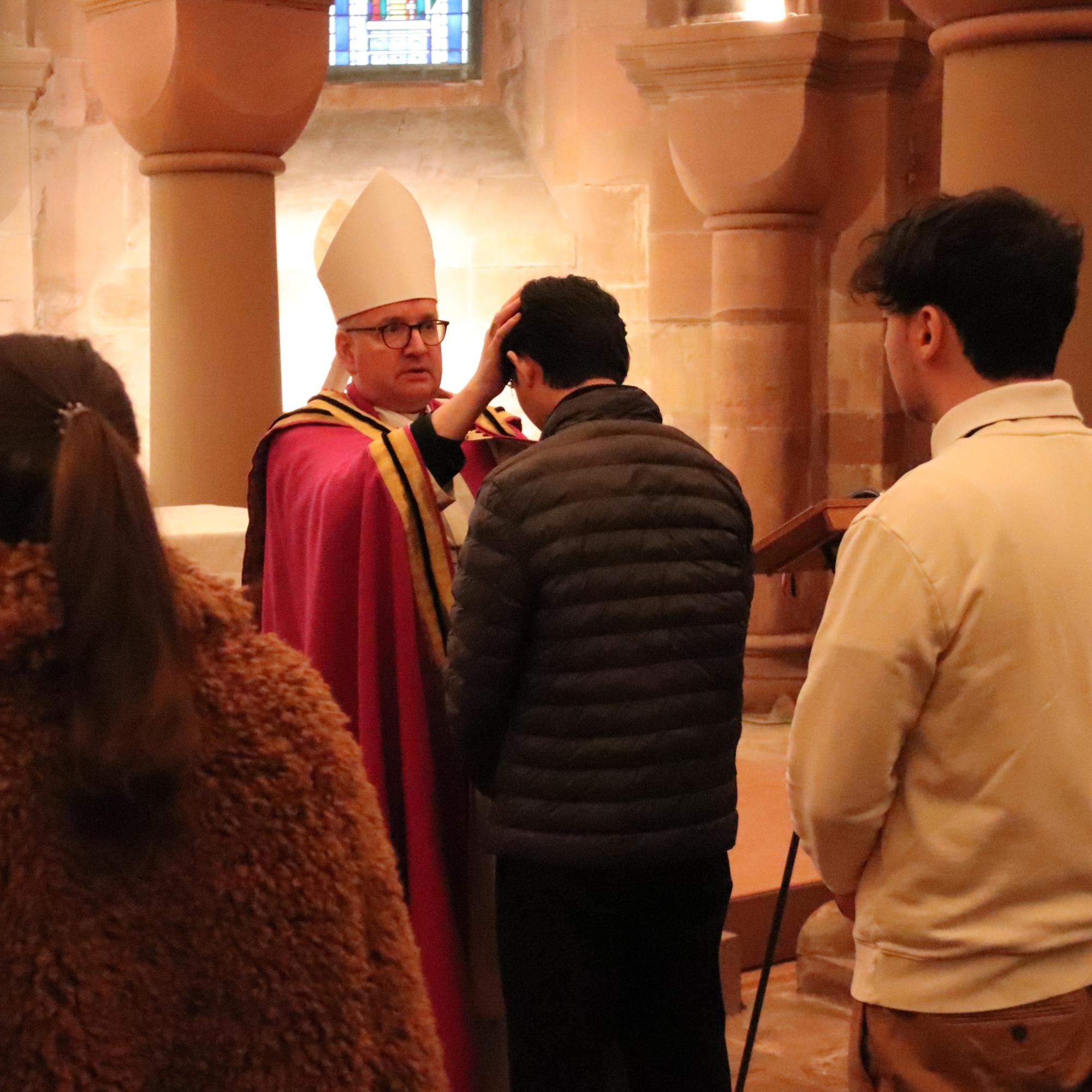 Bischof Kohlgraf legte den Taufbewerberinnen und Taufbewerbern die Hände auf und segnete sie