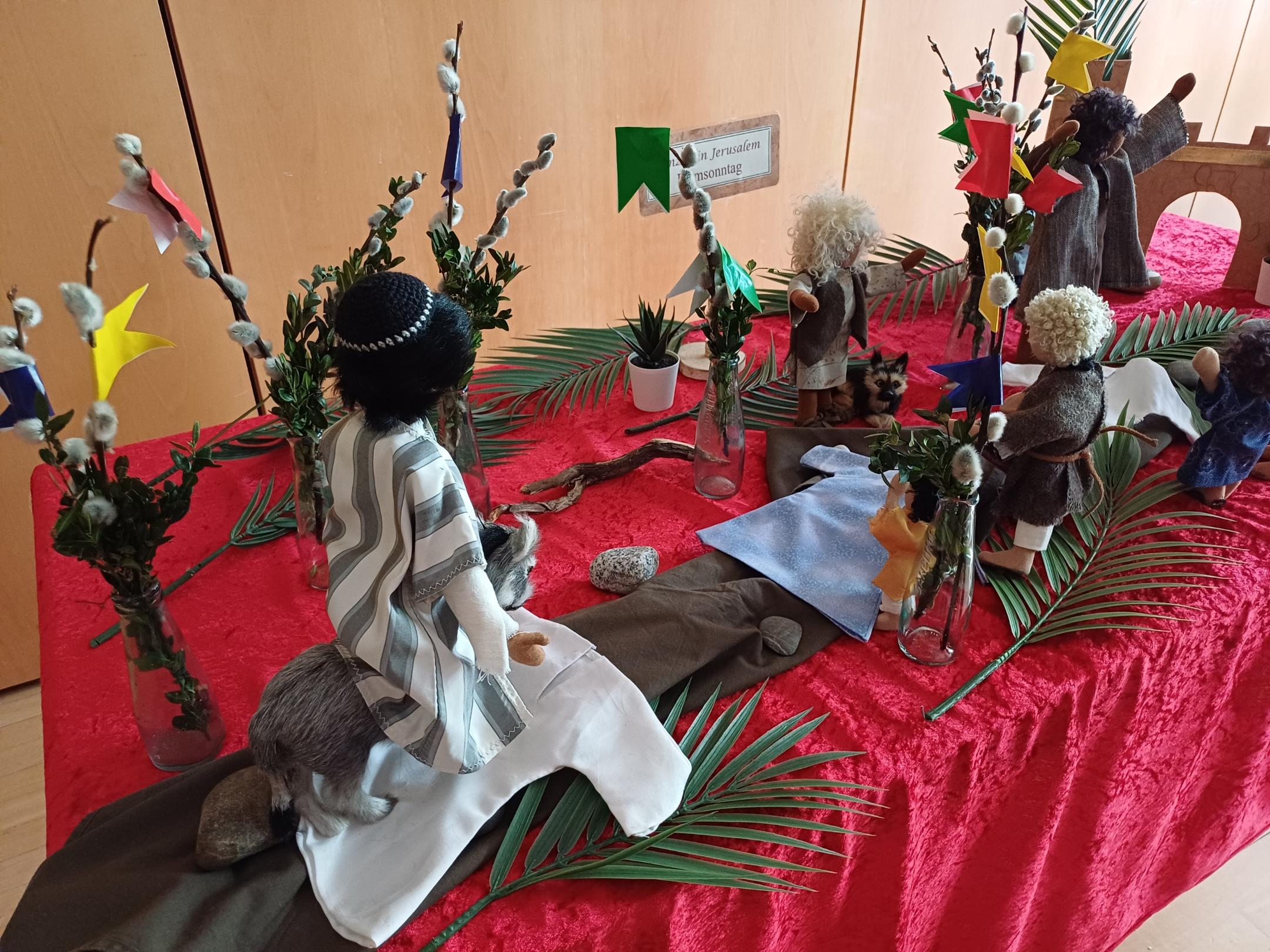 Mit biblischen Erzählfiguren ist der Einzug Jesu nach Jerusalem dargestellt