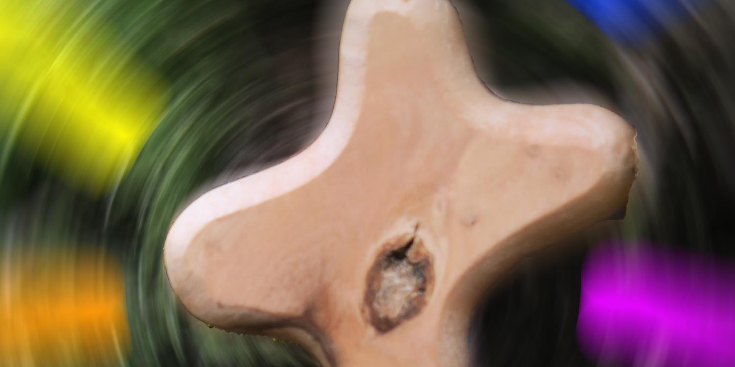 Kreuz vor diffusem Farbhintergrund