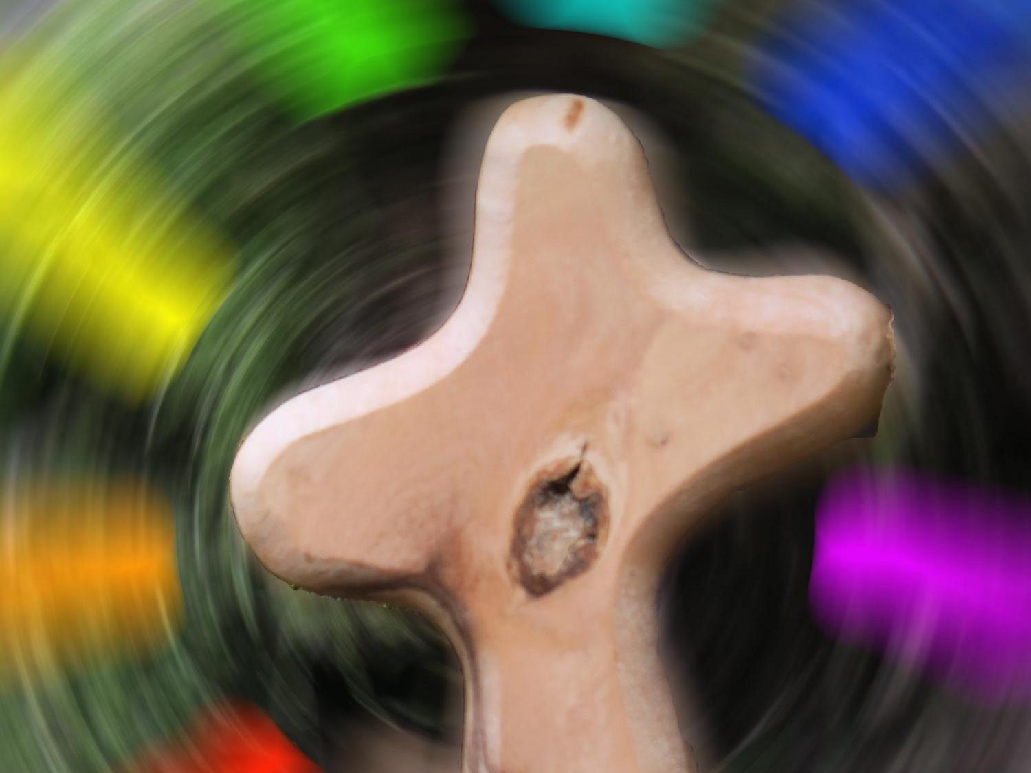 Kreuz vor diffusem Farbhintergrund