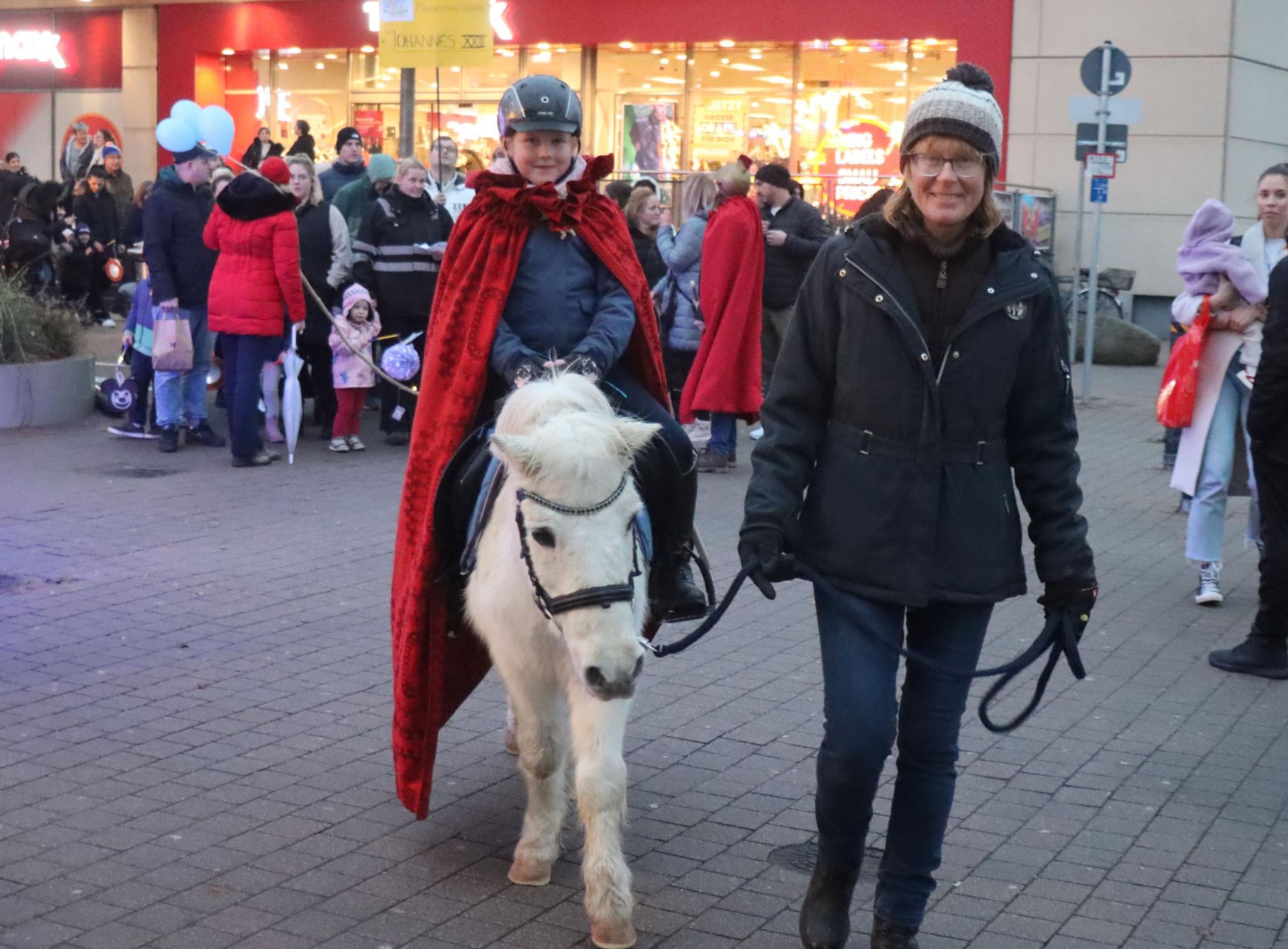 Anja Chladek und ihr Pony führen mit Leni als Hl. Martin den Laternenzug an.