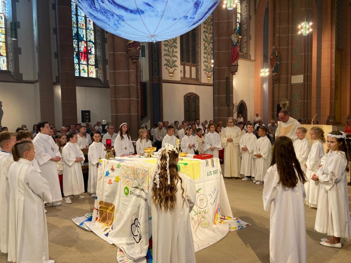 Die Kommuionkinder empfangen den Leib Christi.