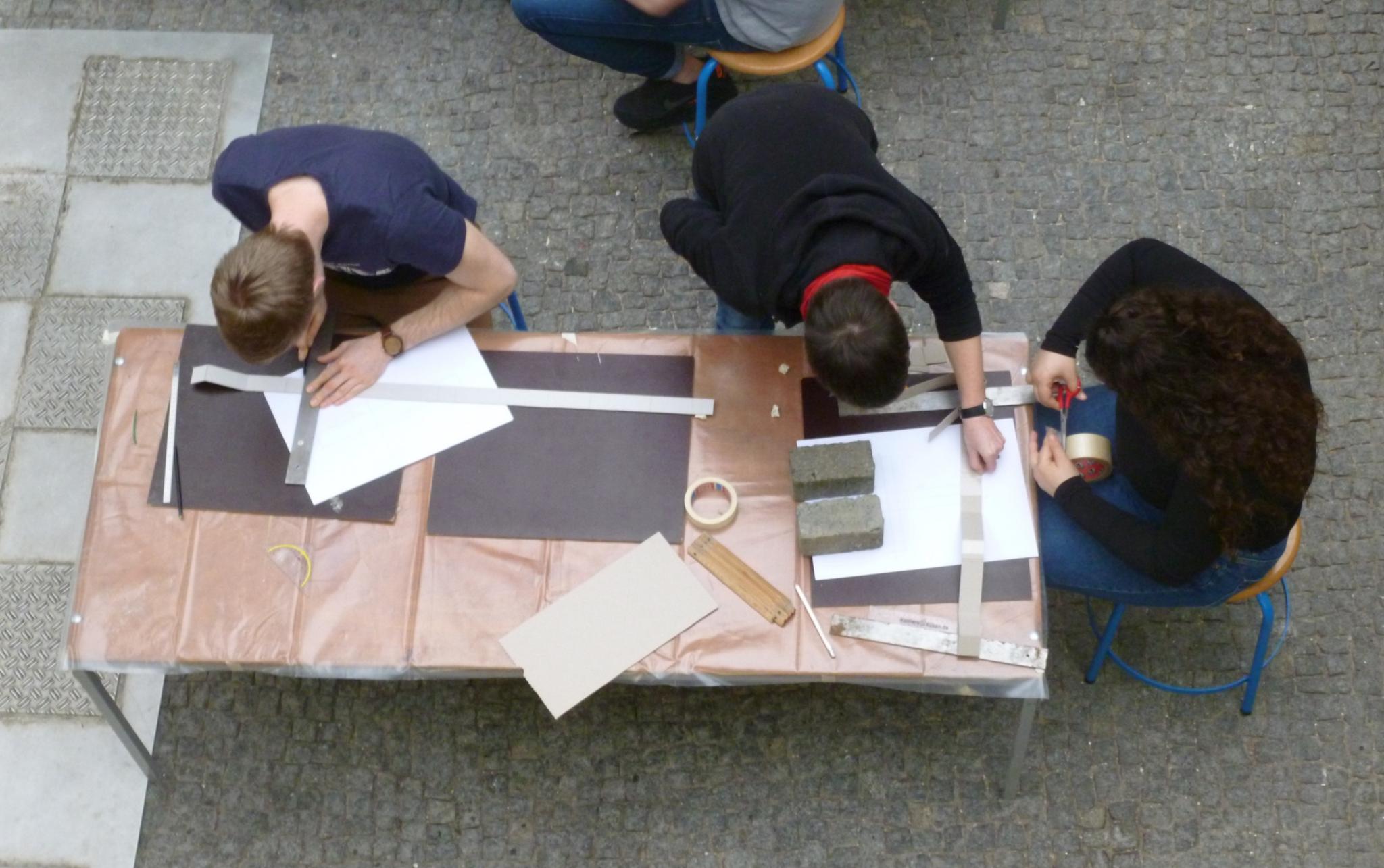 Studierende bei der Arbeit an Kreuzen aus Beton